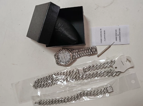 Multiple styles of diamond-encrusted watches, diamond-patterned Cuban bracelets and necklaces, three-piece watch sets