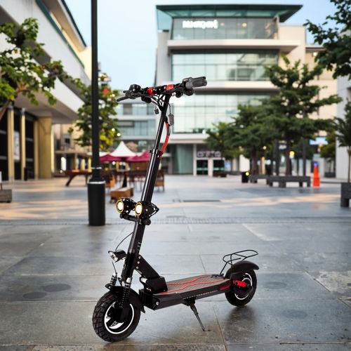 Foldable electric scooter for adults featuring dual suspension, a seat, and a carrying handle.