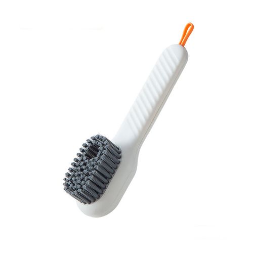 Multi-functional liquid-dispensing shoe brush, a household tool for pressing to dispense liquid and clean shoes