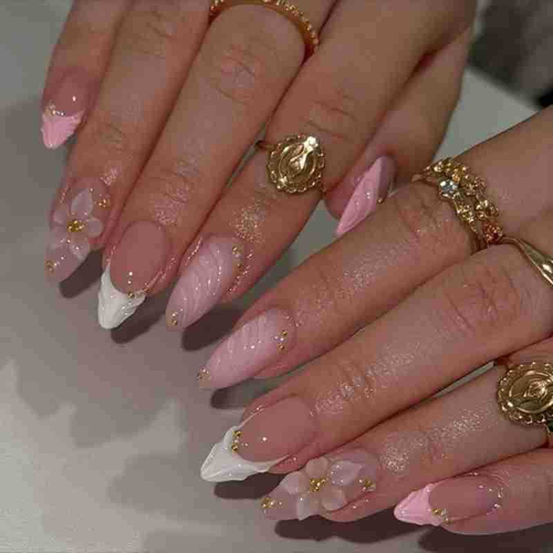 Pink French style 3D sculpted press-on nails with floral designs, gold beads, and almond shape.