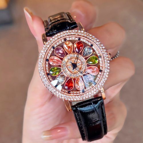 Ladies' watch with rotating dial and colored simulated diamonds