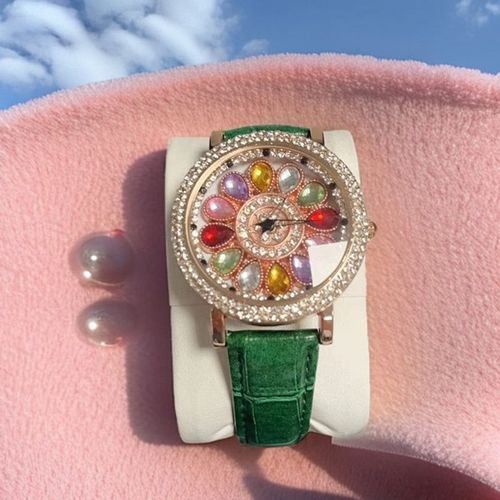 Ladies' watch with rotating dial and colored simulated diamonds