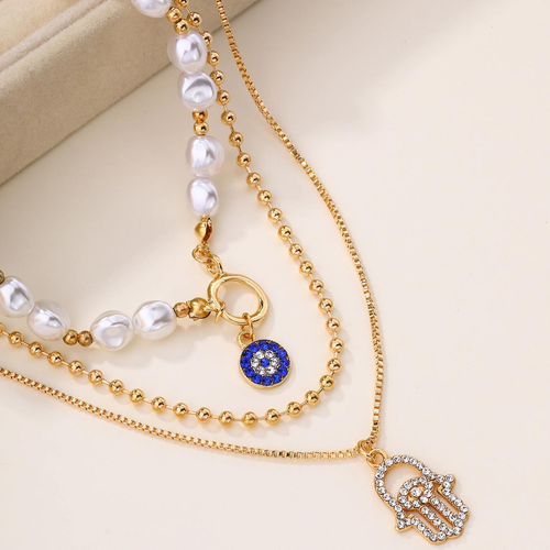 Multi-layered necklace with a gold-plated alloy pearl pendant.