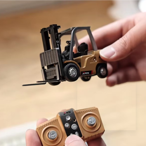 Mini Empilhadeira Remota 1:64, com carroceria de liga leve que replica a sensação de um veículo de engenharia.  Os garfos podem ser levantados e abaixados remotamente, e inclinados para frente e para trás.  O controle remoto 2.4G é preciso e sensível.  Tem o tamanho de uma palma e não ocupa muito espaço.  É adequado para momentos de diversão no trabalho, educação infantil, coleção de modelos, permitindo que você experimente o prazer emocionante de controlar no seu desktop.