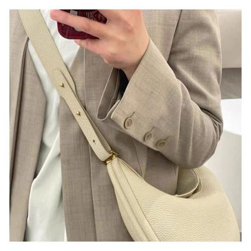 Sophisticated understated-luxury crescent-shaped handbag a versatile solid-color bag perfect for work commuting or everyday use can be carried by hand worn over the shoulder crossbody or tucked under the arm.