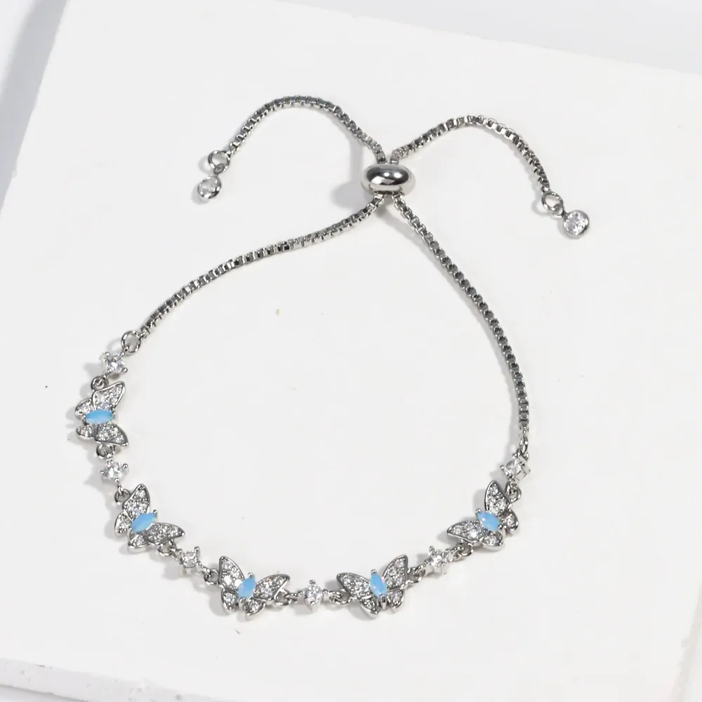 New electroplated adjustable pull-out bracelet with blue zircon and bowknot design.
