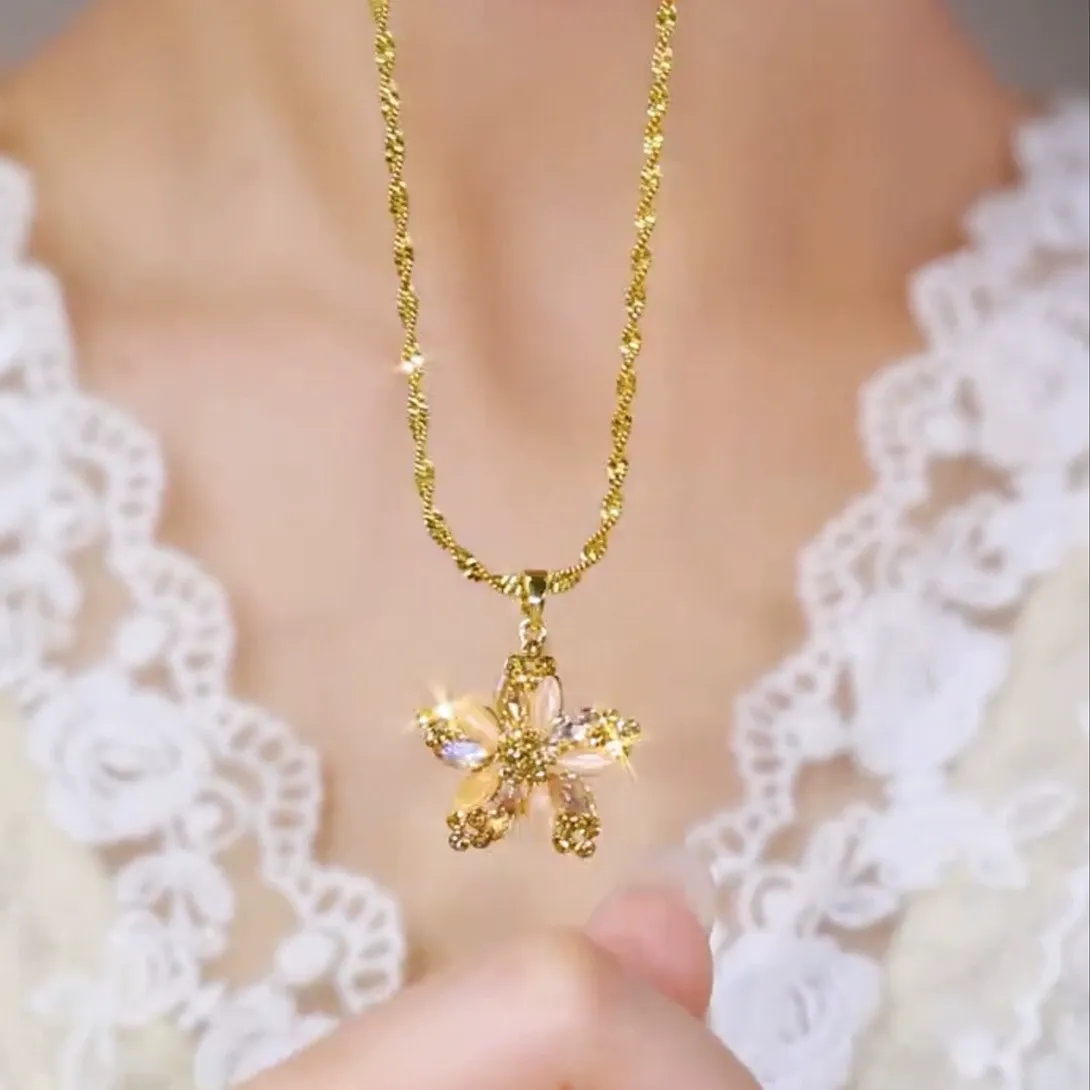 Champagne gold plated necklace with a diamond-encrusted five-pointed star and small flower pendant for women.
