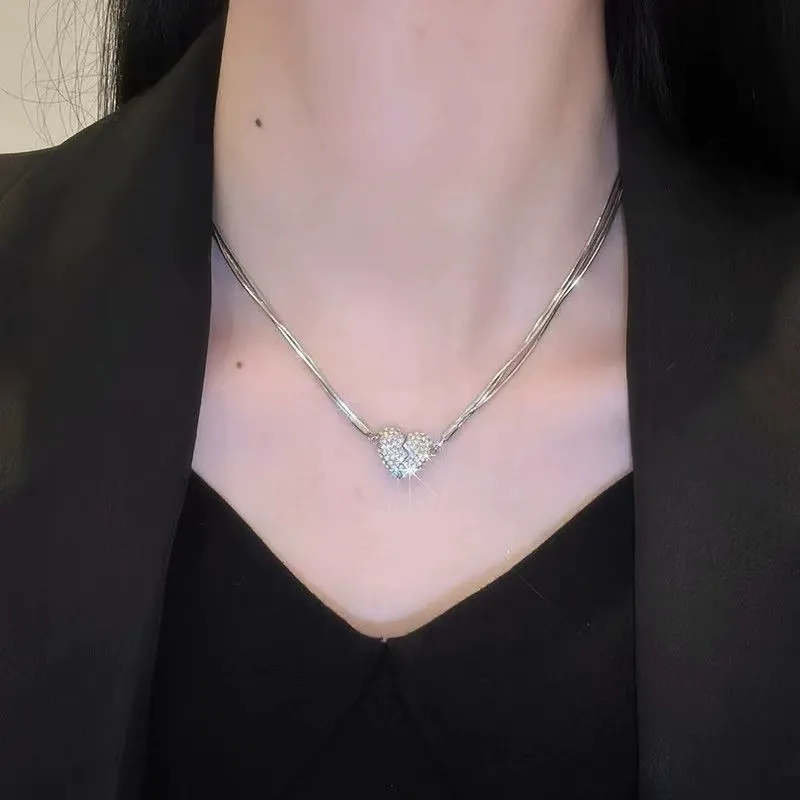 Niche design necklace with diamond-encrusted heart and magnet.