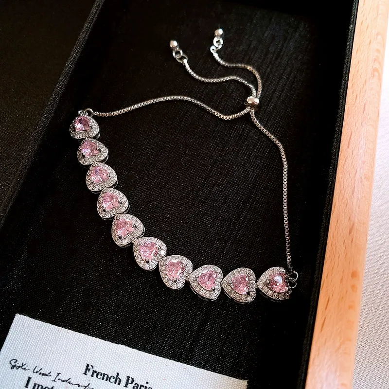 Pink heart-shaped, fully encrusted with sparkling cubic zirconia, adjustable stretch bracelet for women.