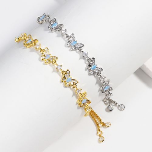 New electroplated adjustable pull-out bracelet with blue zircon and bowknot design.
