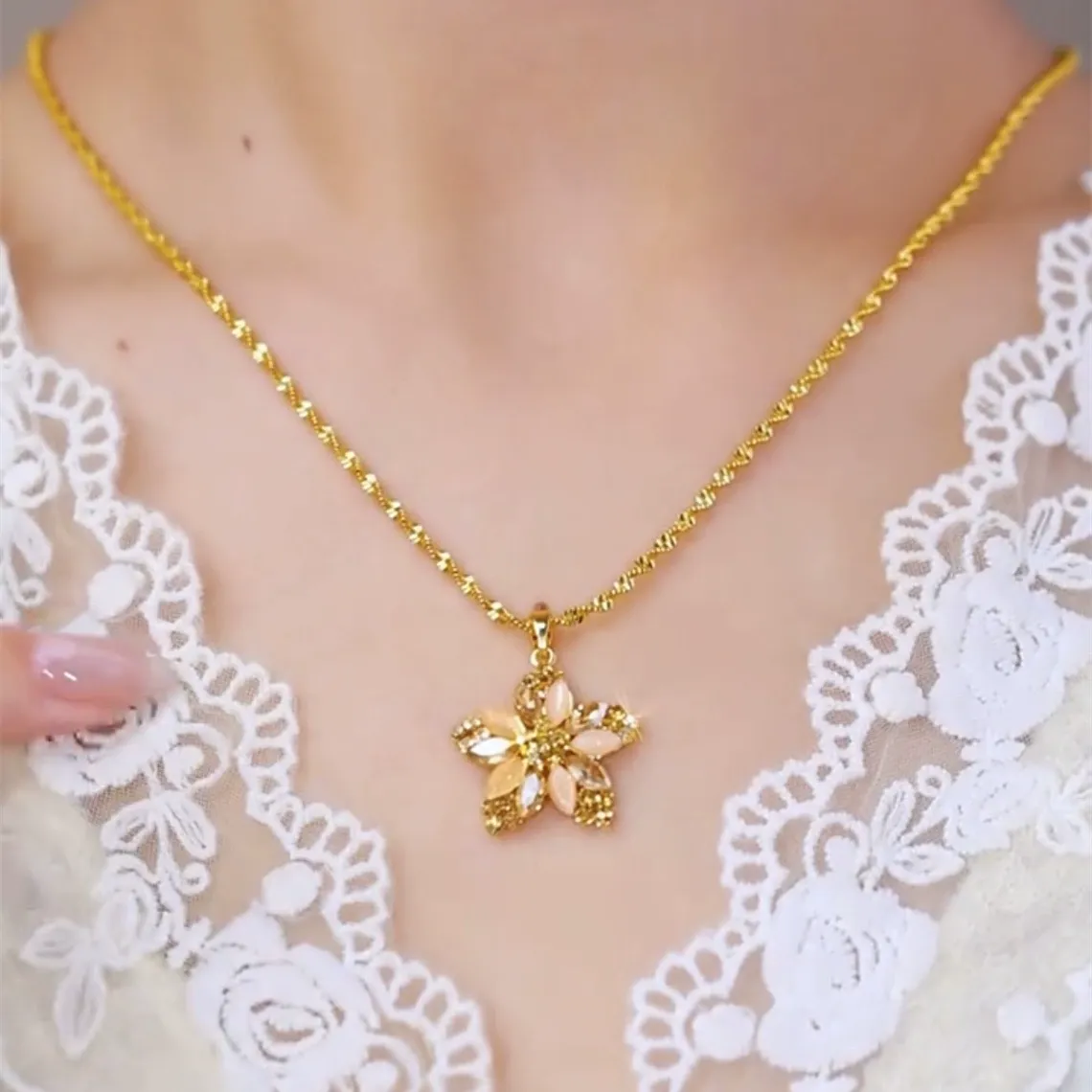 Champagne gold plated necklace with a diamond-encrusted five-pointed star and small flower pendant for women.