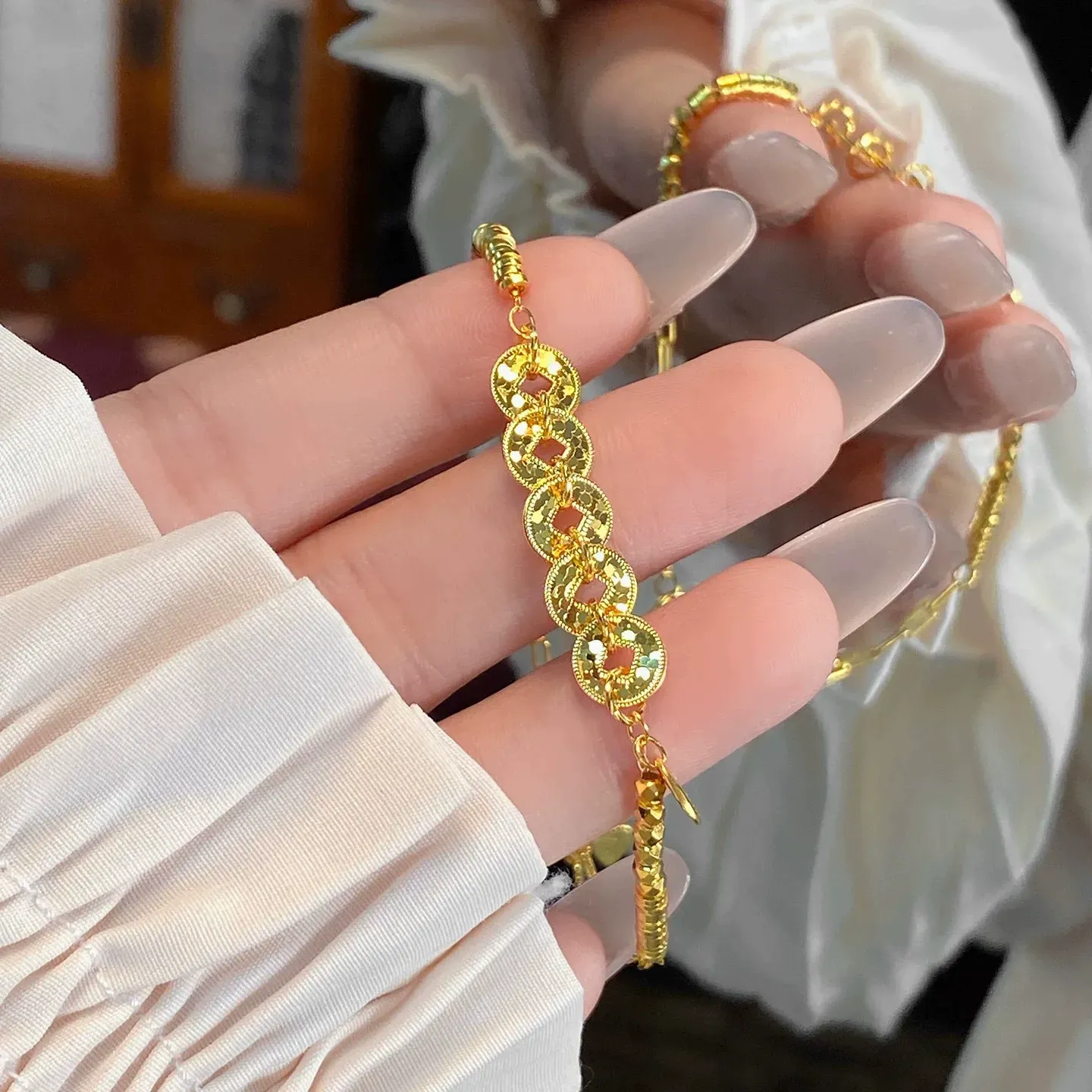 This is a delicate bracelet featuring a five-emperor coin design with a high-quality gold plating and color retention.