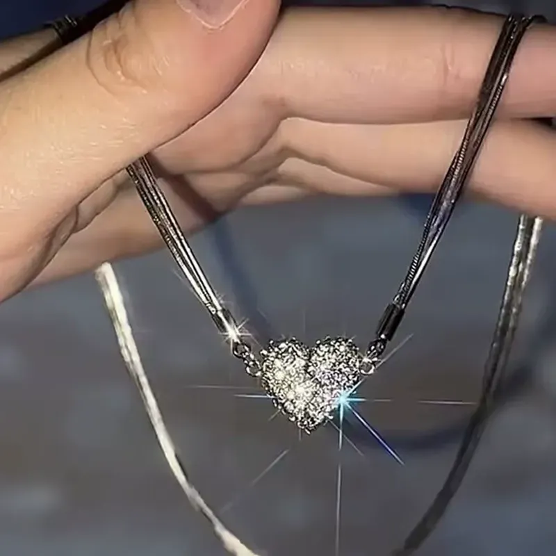 Niche design necklace with diamond-encrusted heart and magnet.