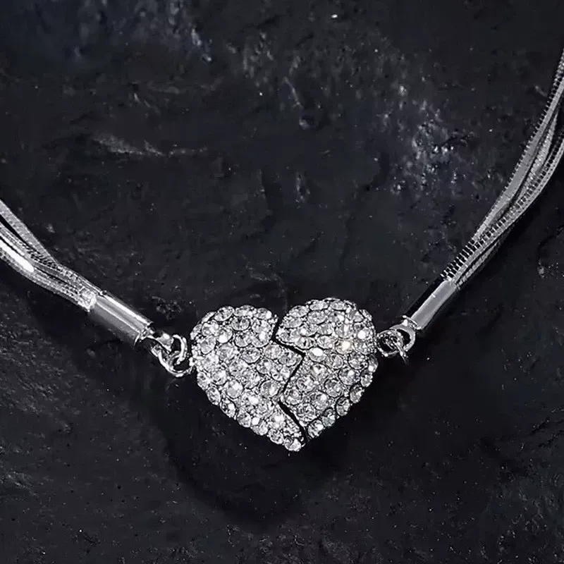 Niche design necklace with diamond-encrusted heart and magnet.