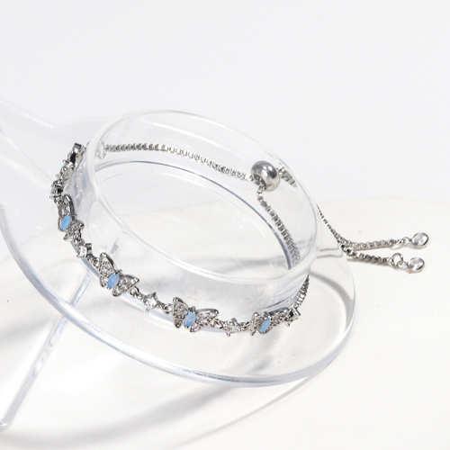 New electroplated adjustable pull-out bracelet with blue zircon and bowknot design.
