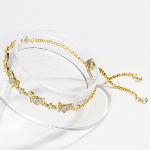 New electroplated adjustable pull-out bracelet with blue zircon and bowknot design.