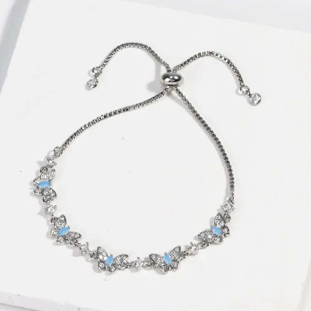 New electroplated adjustable pull-out bracelet with blue zircon and bowknot design.