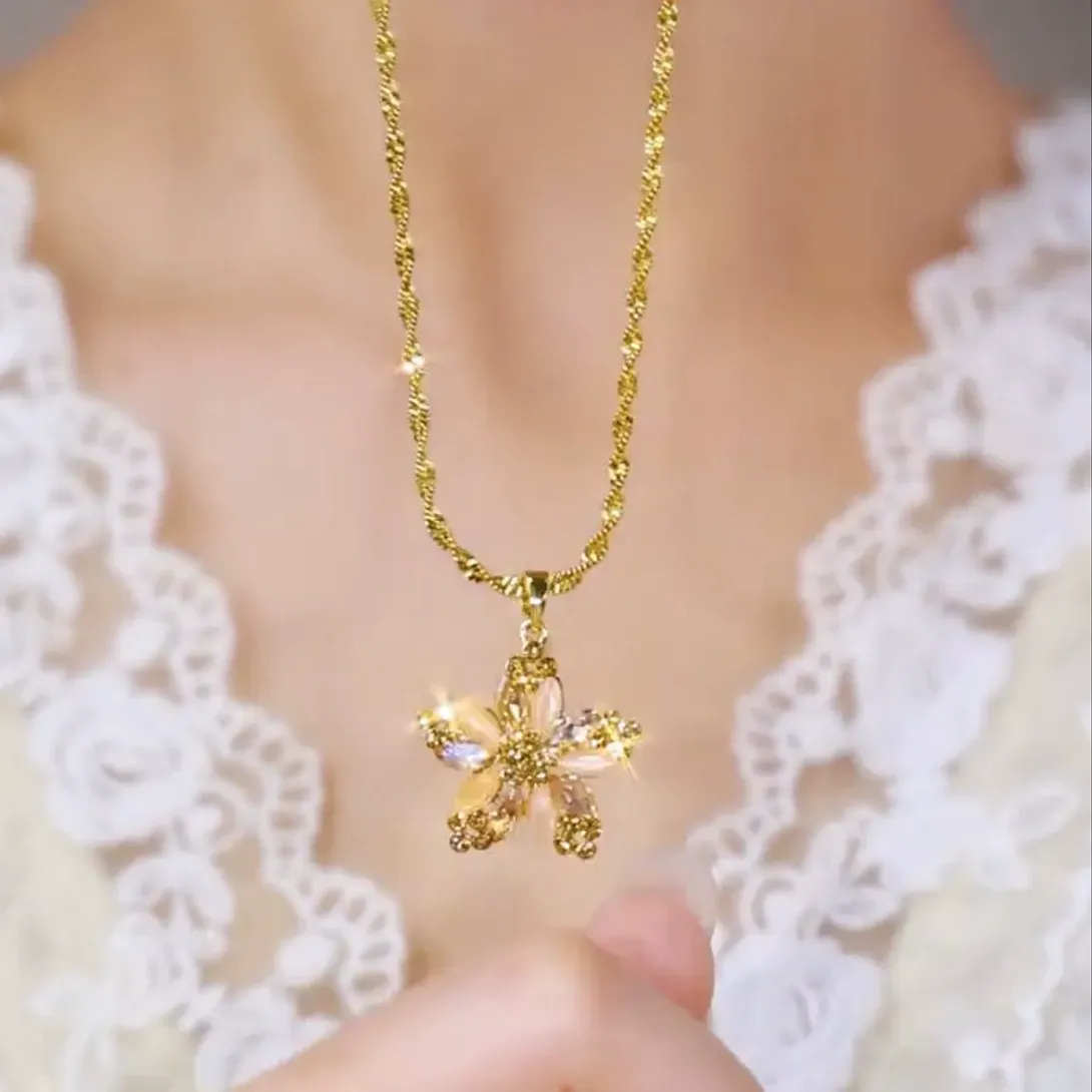 Champagne gold plated necklace with a diamond-encrusted five-pointed star and small flower pendant for women.