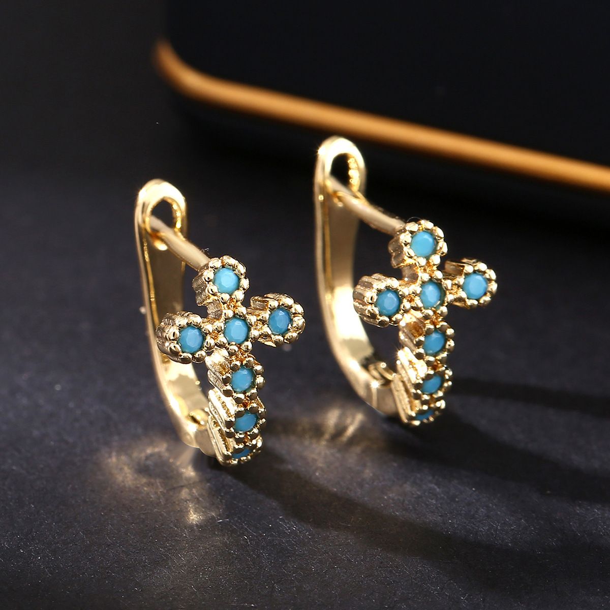 Copper inlaid zirconium cross ear buckle
