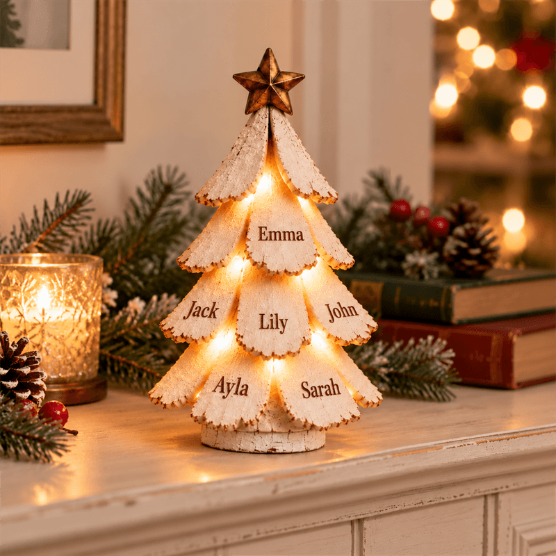 Personalised snowy Christmas tree with six names glowing on a mantelpiece