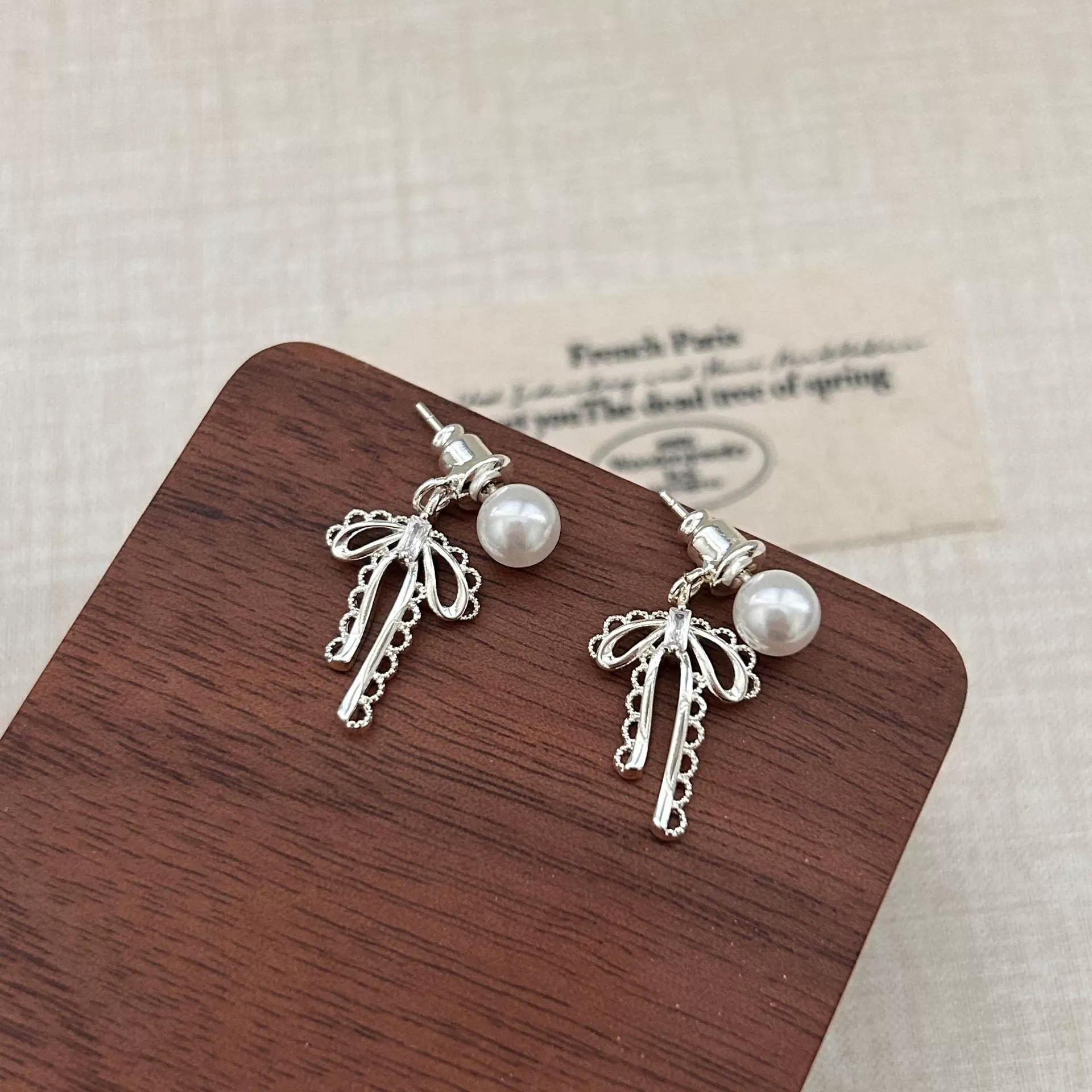 Ballet-style bow ear studs matte silver