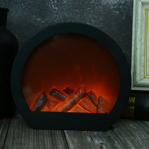 This LED imitation charcoal flame lamp features a semi-circular shape with a transparent window and is equipped with simulated charcoal inside. The LED light simulates the glow of charcoal fire, without any open flame or smoke. It is only used for creating an atmosphere and does not have a heating function. When placed on the table, it is suitable for creating a cozy atmosphere in homes or guesthouses. When using it, keep it away from flammable items.