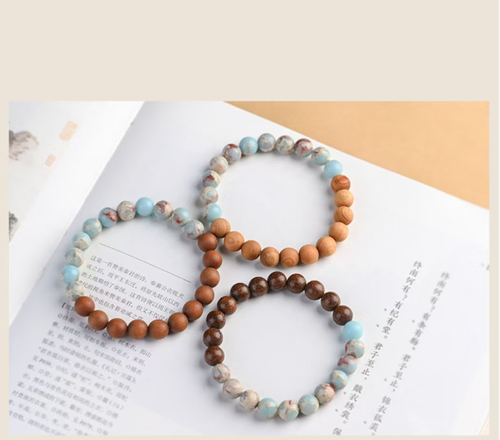 The Cliff Cypress Wealth Energy Bracelet is meticulously crafted using natural cliff cypress and rare gemstones such as Shoushan stone. It exudes a delicate fragrance that boosts energy and brings good fortune. The powerful energy gathers wealth. Order today and we will send you 10 Cliff Cypress Wealth Energy Bracelets. Wearing it will allow the power of nature to protect your path to wealth and keep good luck by your side.