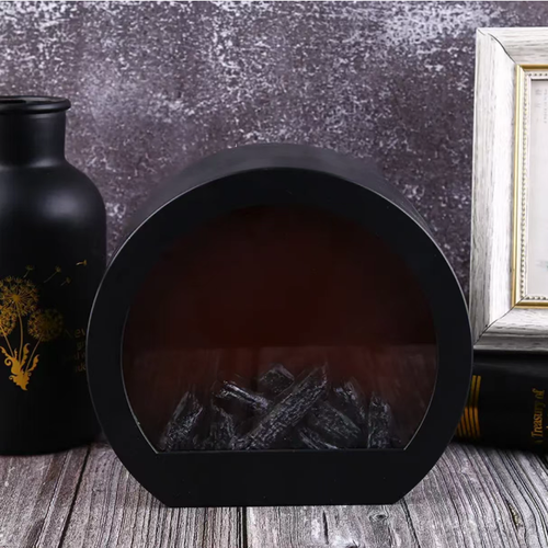 This LED imitation charcoal flame lamp features a semi-circular shape with a transparent window and is equipped with simulated charcoal inside. The LED light simulates the glow of charcoal fire, without any open flame or smoke. It is only used for creating an atmosphere and does not have a heating function. When placed on the table, it is suitable for creating a cozy atmosphere in homes or guesthouses. When using it, keep it away from flammable items.