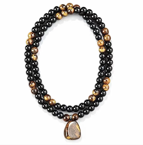 Black obsidian paired with yellow tiger eye stone long cardigan chain. The original stone pendant has a naturally unique texture. The beads are smoothly and roundly polished, and the rope lines are firm and durable. The overall length is moderate, which enhances the figure. It is retro and stable, suitable for various clothing styles, and is suitable for both men and women. It is very suitable for daily wear and as a gift.