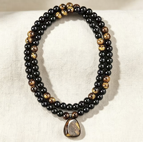 Black obsidian paired with yellow tiger eye stone long cardigan chain. The original stone pendant has a naturally unique texture. The beads are smoothly and roundly polished, and the rope lines are firm and durable. The overall length is moderate, which enhances the figure. It is retro and stable, suitable for various clothing styles, and is suitable for both men and women. It is very suitable for daily wear and as a gift.