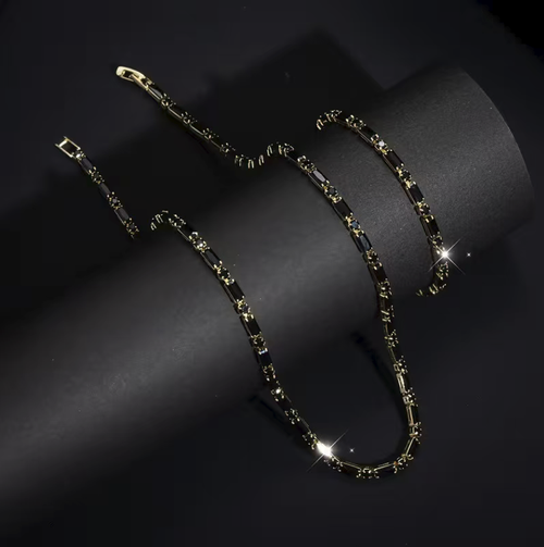 Hip-hop style black zircon necklace and bracelet set, suitable for both men and women. The zircons are neatly set and paired with golden borders, giving a unique texture. The chain body has adjustable clasps, allowing for easy adjustment of the length. It is convenient to wear and take off. It is suitable for daily and party wear. It can be worn as a set or individually. Please pay attention to daily maintenance.