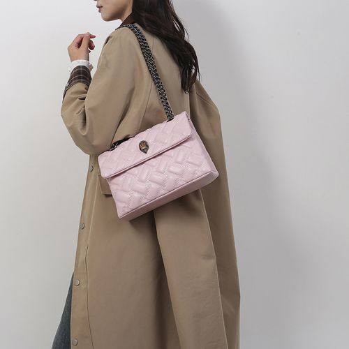 PU leather handbag with eagle head design, a unique and niche design, featuring a diamond-quilted pattern, chain strap, and flap closure.