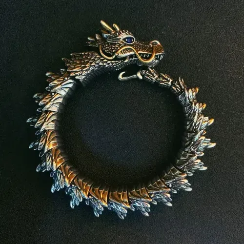 Dragon - shaped bracelet: winding dragon form, golden - horned & bearded head with blue gem eyes, retro and domineering design, dragon - scale - like texture, trendy men's jewelry.