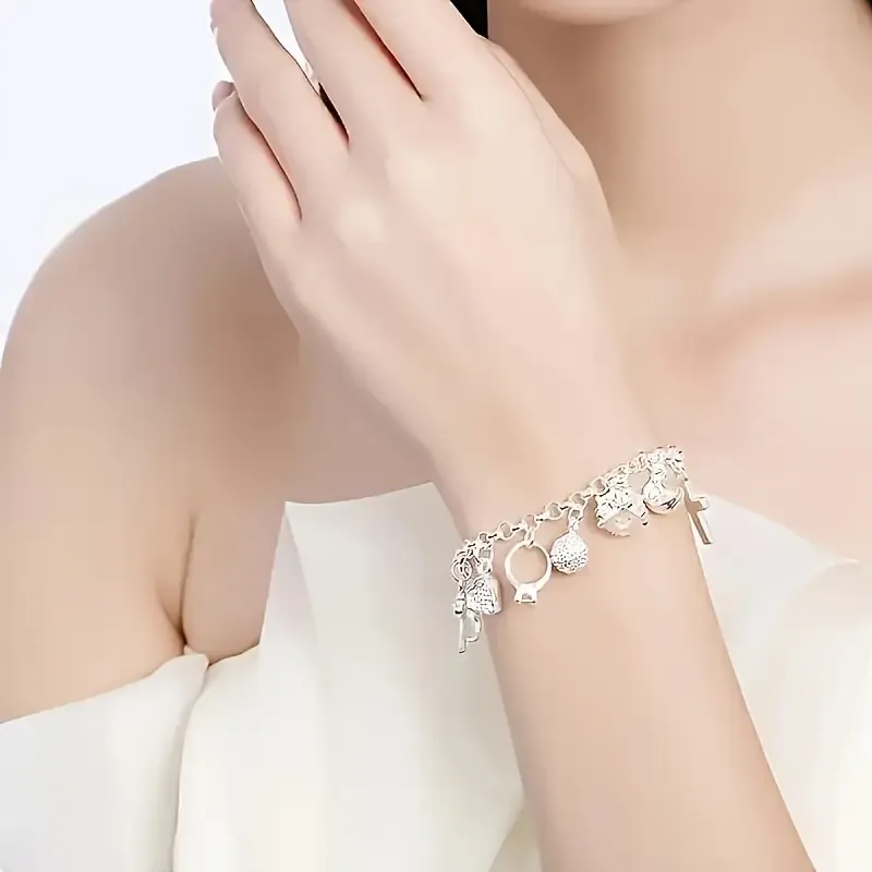 An elegant 925 sterling silver bracelet featuring a heart-shaped key pendant and adorned with 13 exquisite mini-charms, exuding a charming Bohemian style. Boasting a radiant silver luster and meticulous craftsmanship, this fashionable accessory makes an ideal gift for a wife or girlfriend—perfect for birthdays or any special occasion—and serves as a striking, personalized statement piece. (Box not included.)