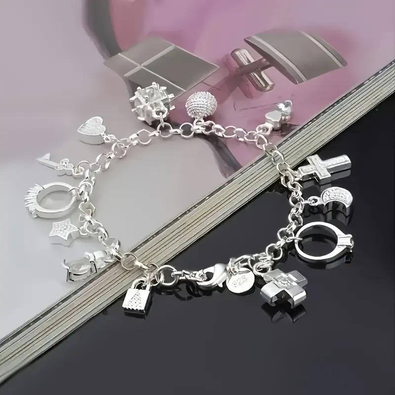 An elegant 925 sterling silver bracelet featuring a heart-shaped key pendant and adorned with 13 exquisite mini-charms, exuding a charming Bohemian style. Boasting a radiant silver luster and meticulous craftsmanship, this fashionable accessory makes an ideal gift for a wife or girlfriend—perfect for birthdays or any special occasion—and serves as a striking, personalized statement piece. (Box not included.)