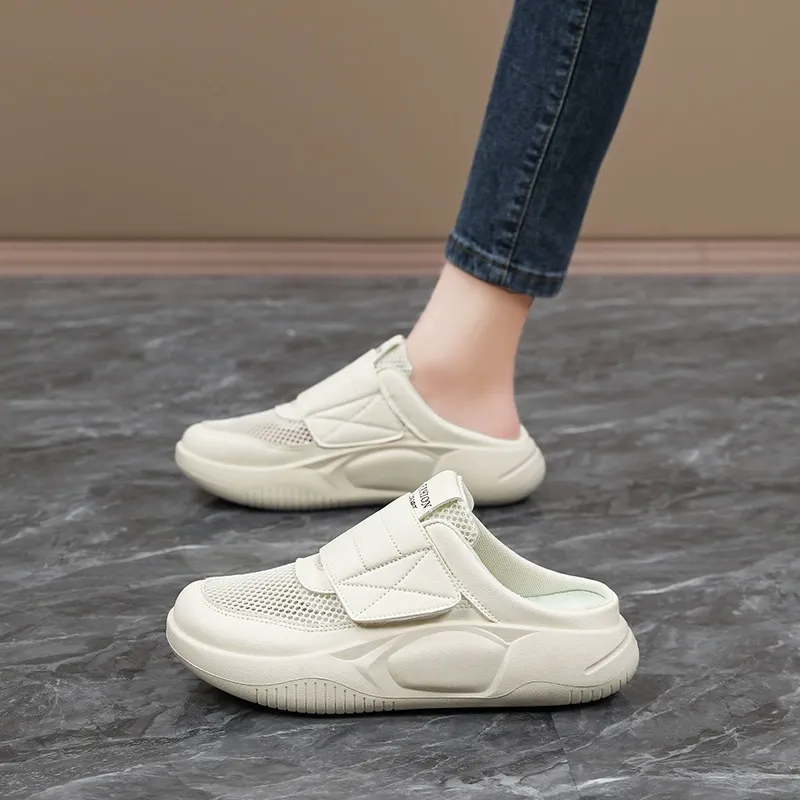 Soft-soled women's shoes are worn on one foot, along with netted sports shoes that cover the toe