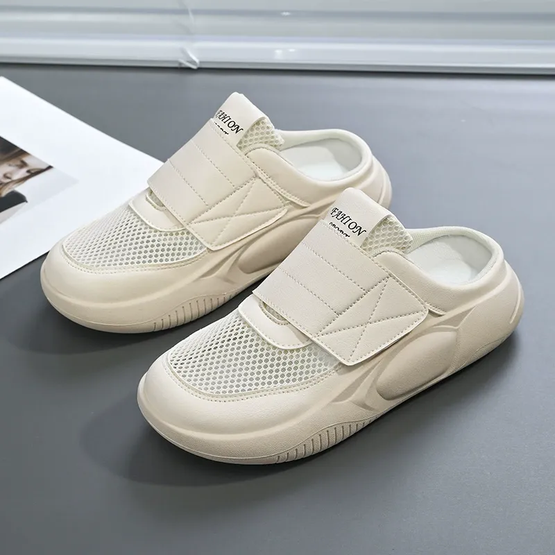 Soft-soled women's shoes are worn on one foot, along with netted sports shoes that cover the toe