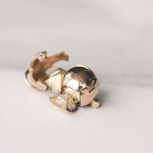 Two-way wearable transforming sphere and cross pendant