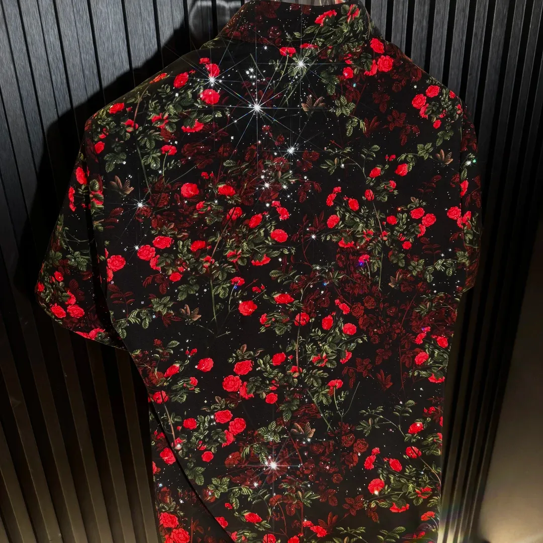 Men's short-sleeve shirt featuring a red flower standing tall on a cliff's edge.