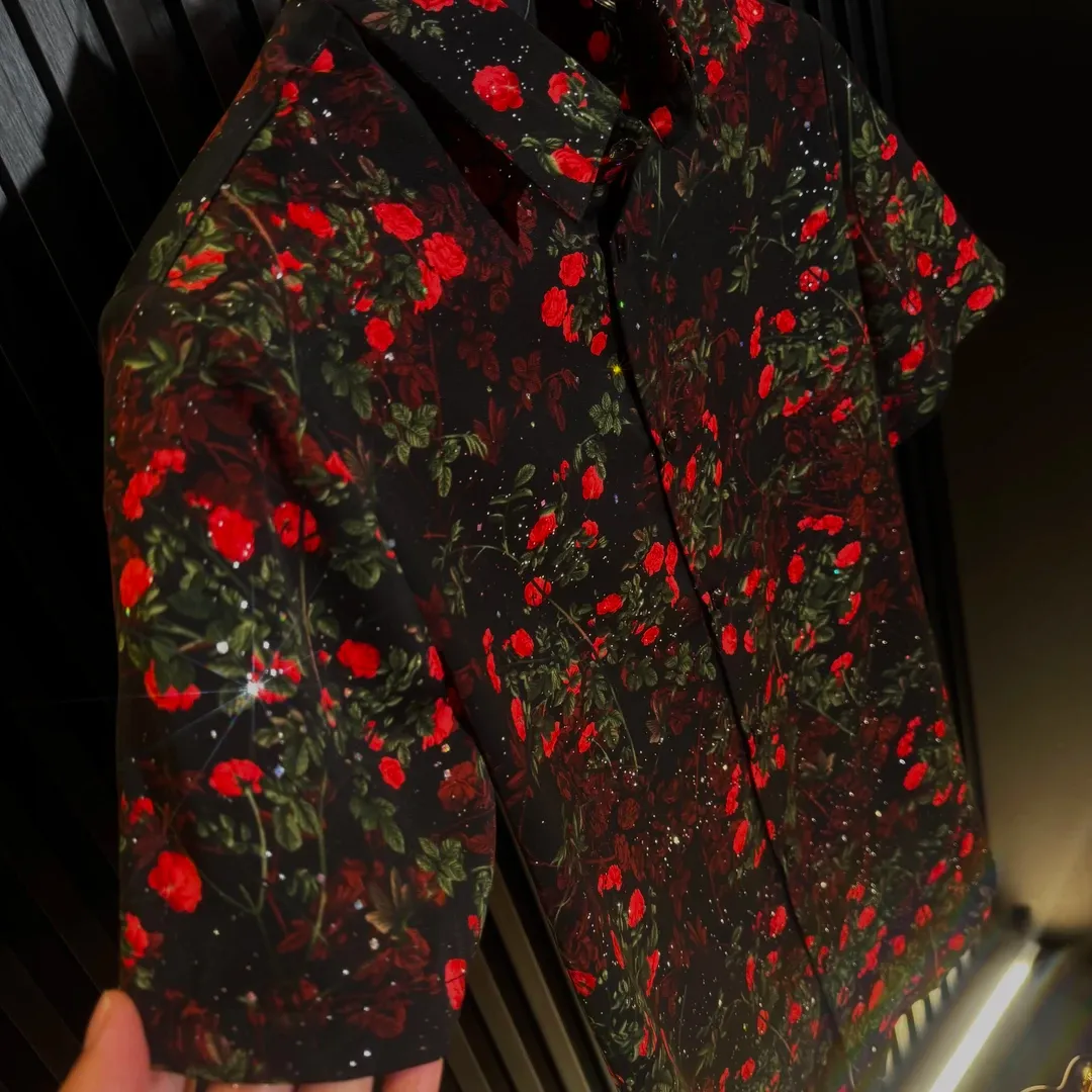 Men's short-sleeve shirt featuring a red flower standing tall on a cliff's edge.