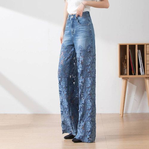 Women's high-waisted blue jeans with wide legs, distressed detailing and lace inserts.
