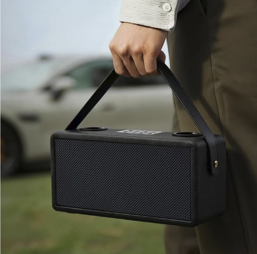 A Bluetooth speaker for karaoke, equipped with two wireless microphones, has a fabric casing and a portable carrying strap. It supports Bluetooth, USB, and memory card playback, offers stereo output, and comes with various singing effects. The built-in battery can be used without power supply, making it suitable for family gatherings and short outdoor activities. It is not suitable for large venues, and high volume can cause distortion.