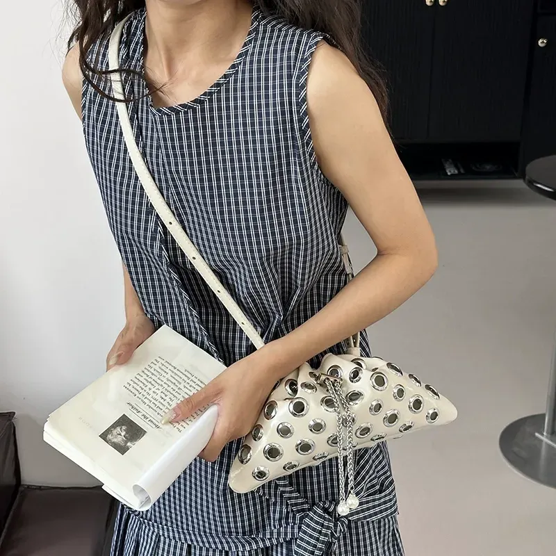 Stylish single-shoulder crossbody bag with openwork drawstring bucket bag, handle with underarm rivets, versatile small bag for women.