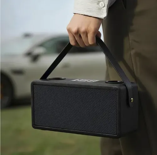 A Bluetooth speaker for karaoke, equipped with two wireless microphones, has a fabric casing and a portable carrying strap. It supports Bluetooth, USB, and memory card playback, offers stereo output, and comes with various singing effects. The built-in battery can be used without power supply, making it suitable for family gatherings and short outdoor activities. It is not suitable for large venues, and high volume can cause distortion.