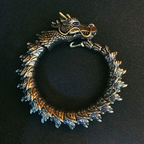Dragon - shaped bracelet: winding dragon form, golden - horned & bearded head with blue gem eyes, retro and domineering design, dragon - scale - like texture, trendy men's jewelry.