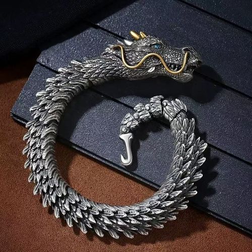 Dragon - shaped bracelet: winding dragon form, golden - horned & bearded head with blue gem eyes, retro and domineering design, dragon - scale - like texture, trendy men's jewelry.
