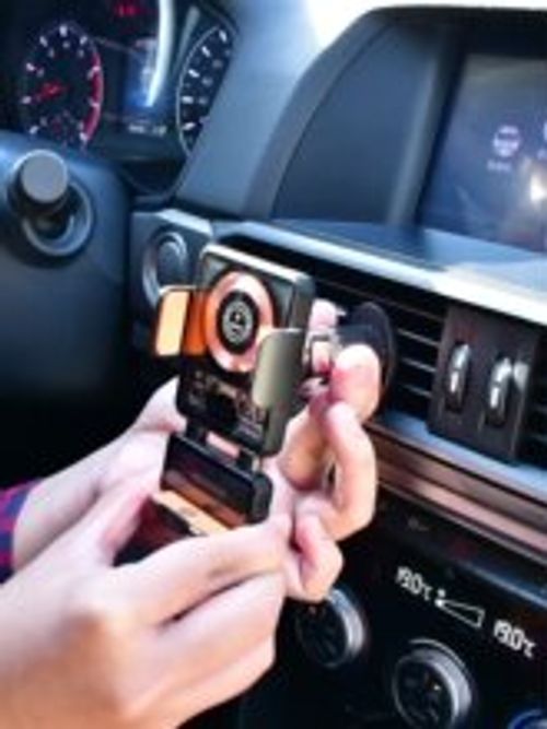 The 2025 new model of car-mounted mobile phone stand is a universal car air outlet modification navigation wireless charging dedicated magnetic fast charging