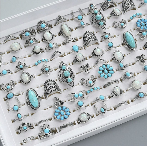Latest trendy rings. A set of 45 rings: 15 in turquoise, 15 in silver, and 15 in gold. All 45 styles are randomly selected and shipped. Wholesale available.
