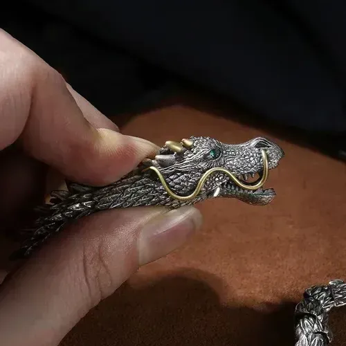 Dragon - shaped bracelet: winding dragon form, golden - horned & bearded head with blue gem eyes, retro and domineering design, dragon - scale - like texture, trendy men's jewelry.