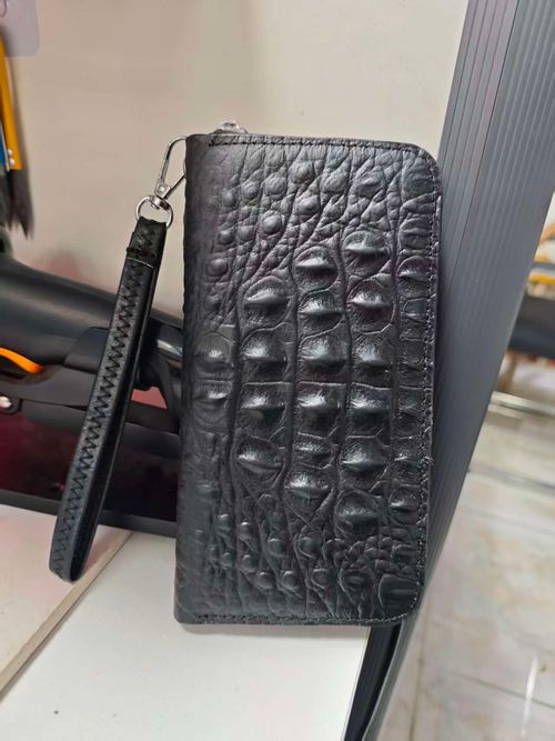 Unisex genuine leather zippered wallet with wrist strap: Features RFID-blocking technology and high-capacity storage, combining the functions of a personalized card holder, clutch, and phone pouch.